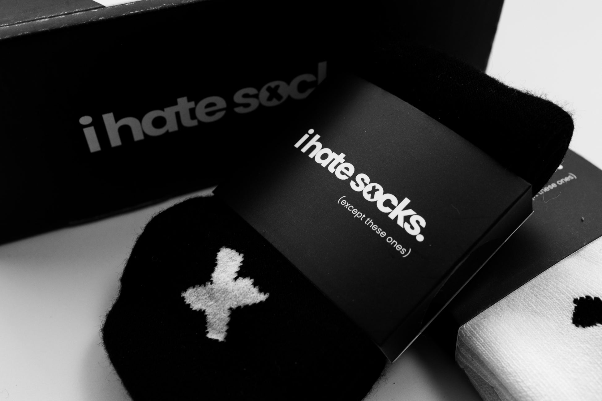 Black bamboo sensory friendly socks with 'i hate socks' text on packaging