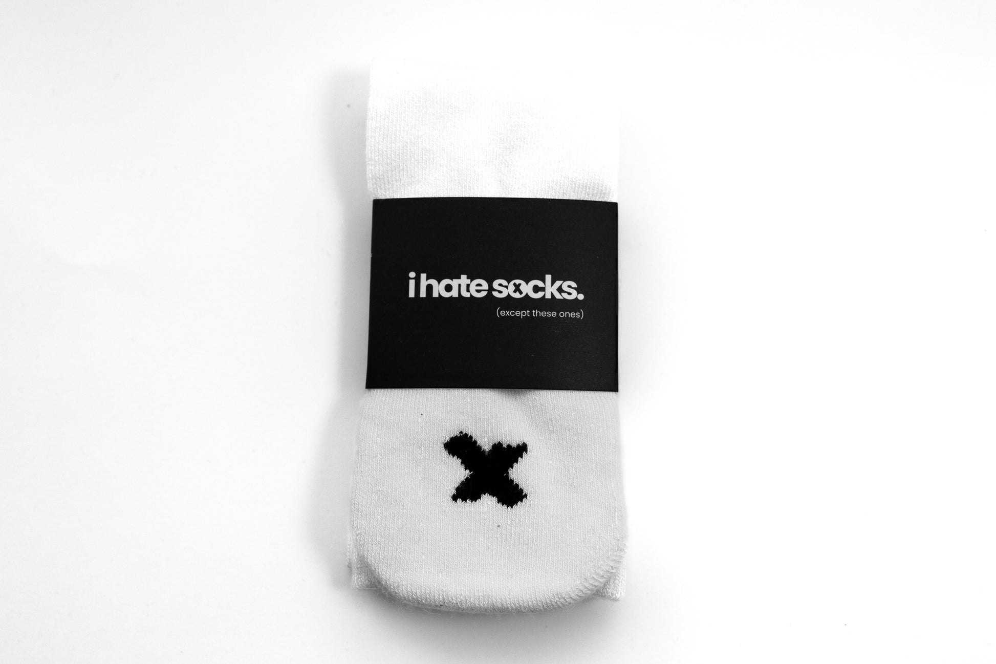 White bamboo seam free, heel free socks with a black 'X' design and 'i hate socks.' label on a white background