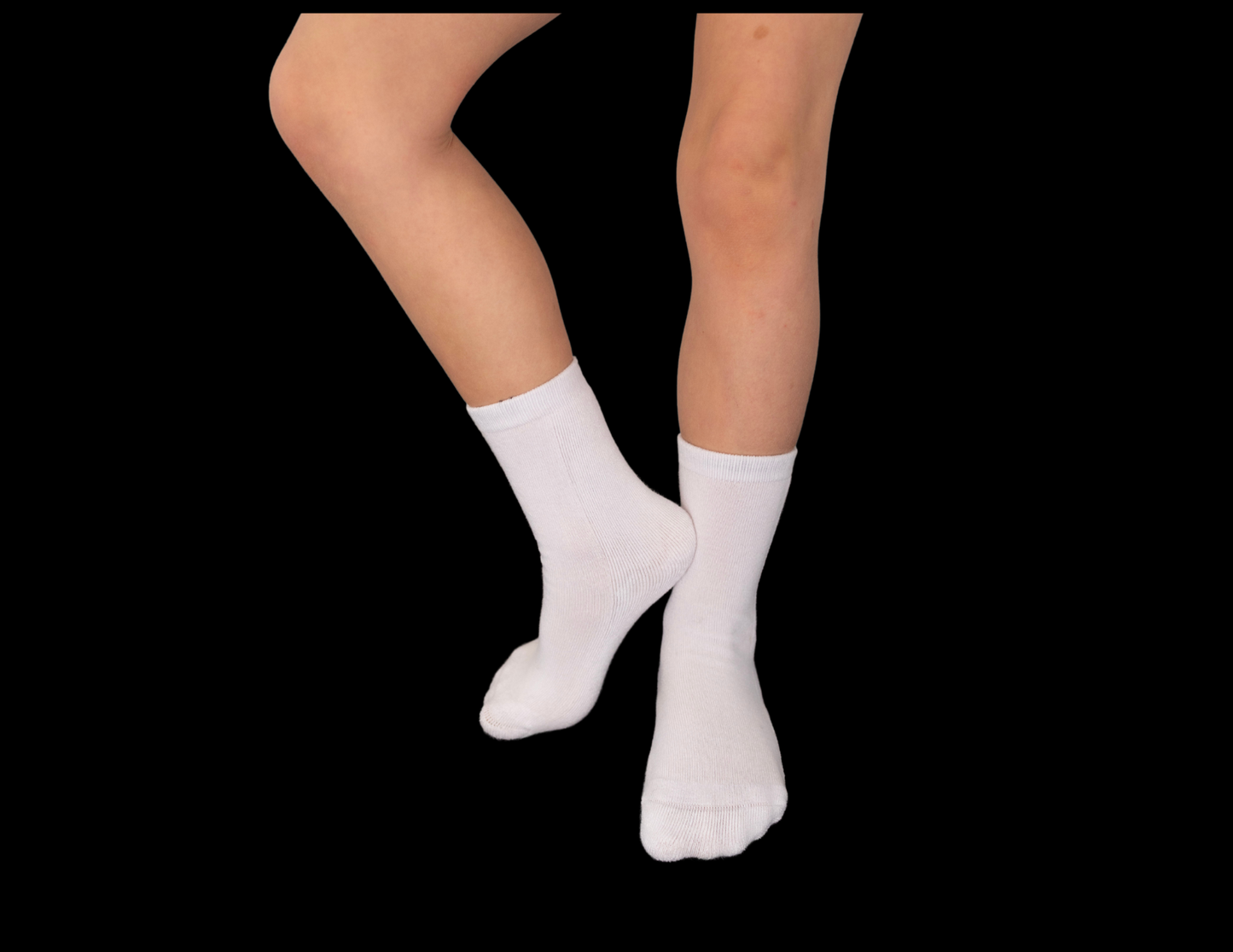 White bamboo seam-free, sensory socks worn by a person on a black background