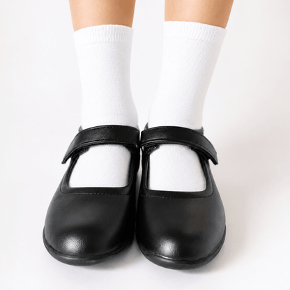 White sensory-friendly seamless socks worn inside black girls school shoes