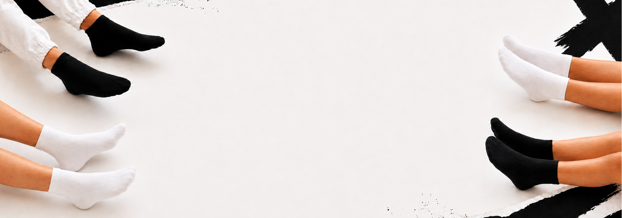 Multiple pairs of socks in black, white, and brown on a light background